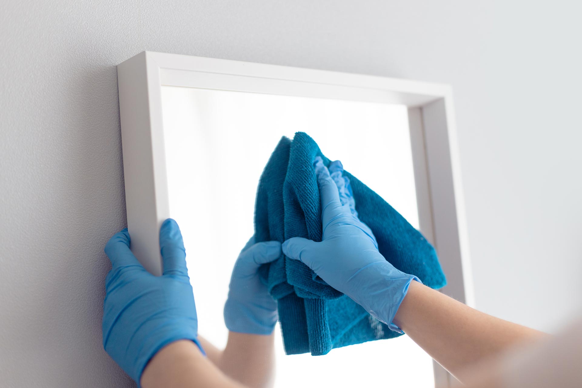 Commercial Cleaning Services cleaning mirror